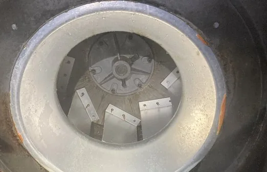 The same fan inlet and wheel washed to bare metal after PowerClean service