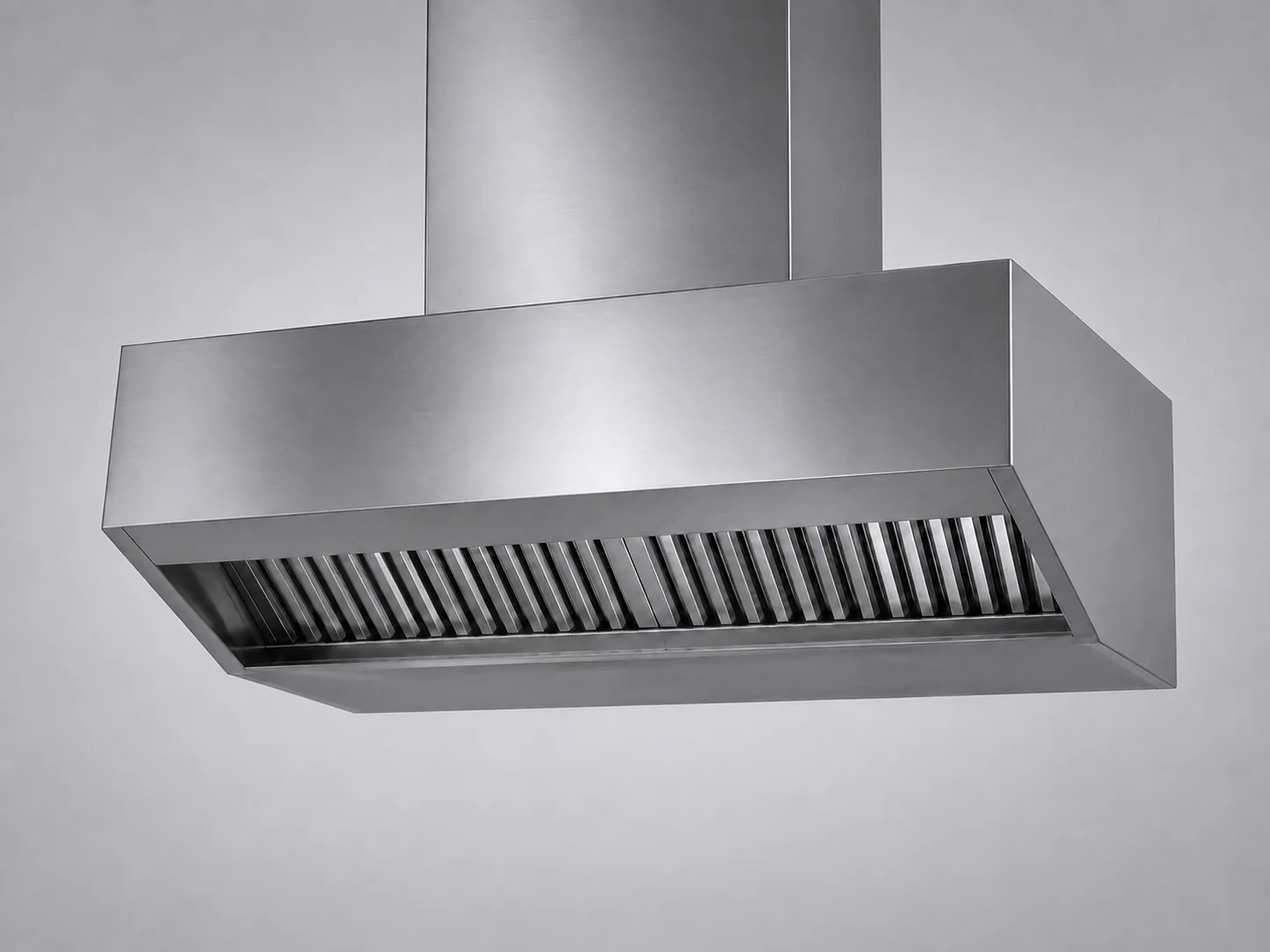 Commercial kitchen hood canopy with its row of angled baffle filters